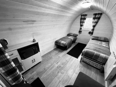 a living room with two beds and a tv at Pentland View Campsite in Haywood