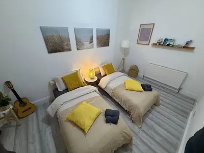 two beds in a room with a guitar at Glasgow centre New property in Glasgow