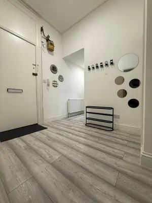 a room with a hallway with wood floors and a door at Glasgow centre New property in Glasgow
