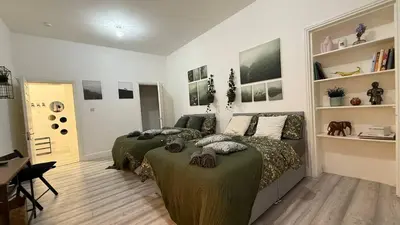 a bedroom with two beds and a desk at Glasgow centre New property in Glasgow