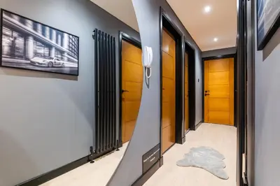 a hallway with doors and a rug on the floor at The Apartment in Paisley