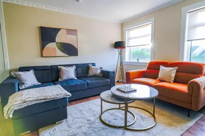 a living room with a couch and a table at Cruachan House in Falkirk