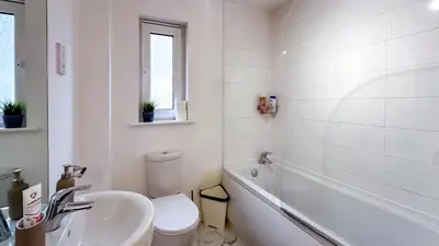 a white bathroom with a toilet and a sink at New Modern Detached House with 5bdr Glasgow in Renfrew