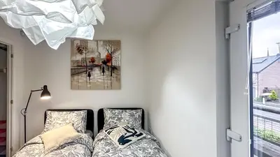a bedroom with a bed and a picture on the wall at New Modern Detached House with 5bdr Glasgow in Renfrew
