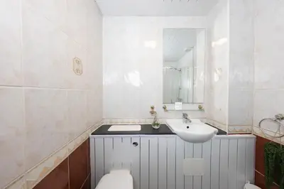 a bathroom with a sink and a toilet and a mirror at Charming and Spacious City Getaway 3 in Edinburgh