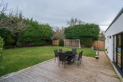a patio with a table and chairs in a yard at Spacious 5-Bed Home with Garden Parking - Pass the Keys in Edinburgh