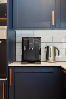 a coffee maker on a counter in a kitchen at Old Kirk Apartment in Oban