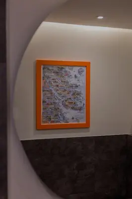 a mirror on a wall with a picture of boats at Old Kirk Apartment in Oban