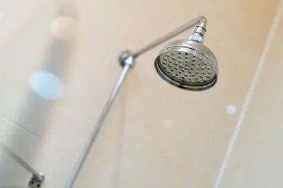 a shower head on a wall in a bathroom at Cleish Apartment in Edinburgh