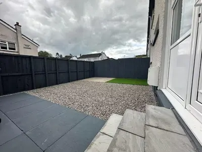 a backyard with a fence and a door at Family - Garden - Parking - WiFi - Sleeps 5 in Tullibody