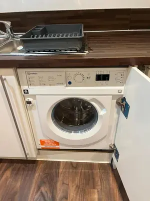 a washing machine with a tray on top of it at City centre luxury apartment in Glasgow