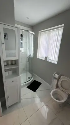 a bathroom with a toilet and a glass shower at Ella's Place in Moffat
