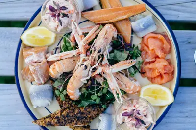 a plate of food with shrimp and other foods at The Corrie Hotel in Corrie