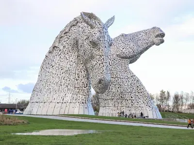 a statue of a horse standing in a field at Beechtree Timber Lodge 69A in Denny