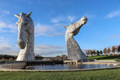 two statues of two horses standing next to a pond at Beechtree Timber Lodge 69A in Denny