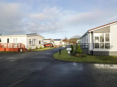 an empty street in front of a house at Beechtree Timber Lodge 69B in Denny