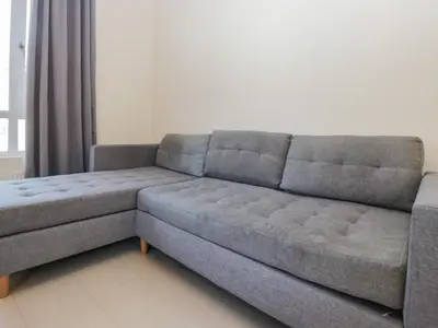 a couch sitting in a living room next to a window at Beechtree Timber Lodge 69B in Denny