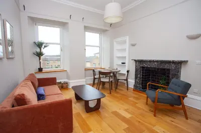 a living room with a couch and a fireplace at Stylish Southside 2 Bedroom Flat with Free Parking in Glasgow