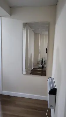 a mirror on a wall in a room at Cosy Retreat Suites in Hamilton