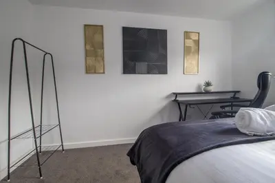 a bedroom with a bed and a table with chairs at The Kings Height close to Glasgow and Edinburgh in Airdrie