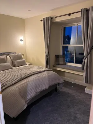 a bedroom with a large bed and a window at Corner House, newly refurbished, Dunning in Dunning