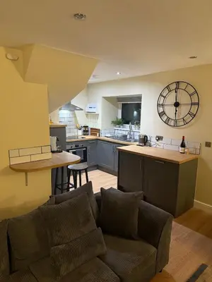 a living room with a couch and a kitchen at Corner House, newly refurbished, Dunning in Dunning