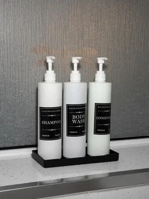 three bottles of shampoo and bleach sitting on a shelf at The Telford Nook in Edinburgh