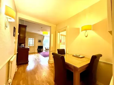 a dining room with a wooden table and chairs at Cozy 1 bed Garden flat in the New Town City Centre in Edinburgh