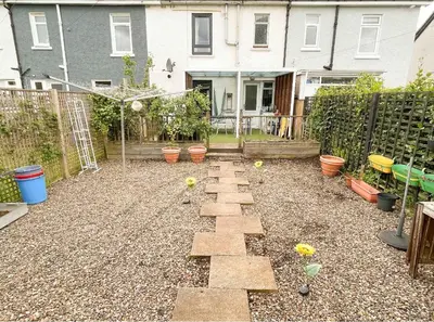 a garden with a stone path in front of a house at Large double room in a house at Glasgow Westend in Knightswood