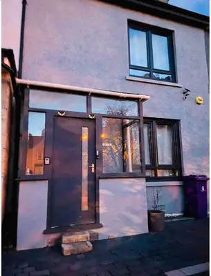 a house with a large door and windows at Large double room in a house at Glasgow Westend in Knightswood