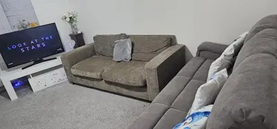 a living room with a couch and a flat screen tv at NG Property in Glasgow