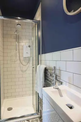 a bathroom with a shower and a sink at Fully licensed studio in peaceful neighbourhood in Edinburgh