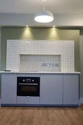 a kitchen with a blue counter and a stove at Fully licensed studio in peaceful neighbourhood in Edinburgh