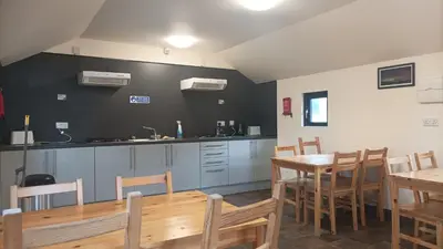 a kitchen and dining room with a table and chairs at Barrhill Holiday Park - Glamping in South West Scotland - Duisk in Girvan