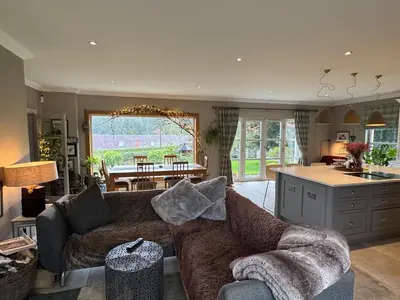 a living room with a couch and a kitchen at Borders Escape with Hot Tub in West Linton