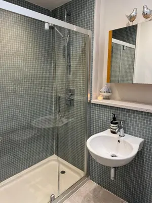 a bathroom with a glass shower and a sink at Borders Escape with Hot Tub in West Linton