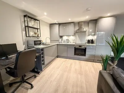 a kitchen with a desk and a computer in a room at 2-Bed Flat in Glasgow East End in Glasgow