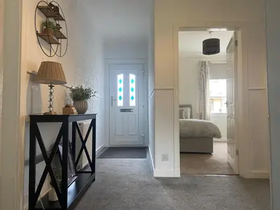 a hallway with a room with a bed and a door at 3BR Sleeps 6 Free Parking Near Glasgow City in Renfrew
