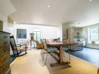 a kitchen and dining room with a table and chairs at The Granary in Moffat