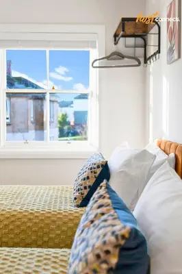 a bedroom with a bed with pillows and a window at Comfortable 2 Bed Airdrie Flat w Private Parking in Airdrie