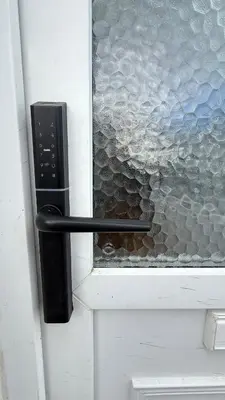 a black door handle on a door with a window at Welcome to your perfect getaway in Glasgow