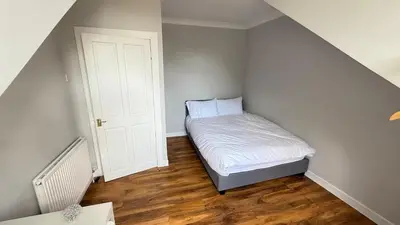 a small bedroom with a small bed in the corner at Welcome to your perfect getaway in Glasgow