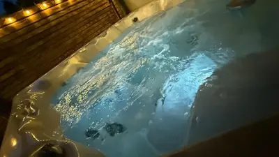 a bath tub filled with water with lights in it at Welcome to your perfect getaway in Glasgow