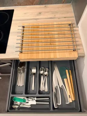a drawer filled with utensils in a wooden drawer at The perfect place we call home 2 in Dumbarton