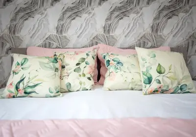 a bedroom with a bed with pillows and a wall at Broomfield No 31 by Klass Living Airdrie in Airdrie