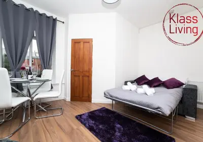 a living room with a couch and a table at Cosy Apartment by Klass Living Bellshill in Bellshill