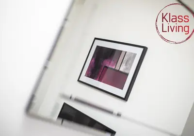 a picture hanging on a wall next to a mirror at Cosy Apartment by Klass Living Bellshill in Bellshill