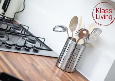 a metal container with utensils on a counter next to a stove at Cosy Apartment by Klass Living Bellshill in Bellshill
