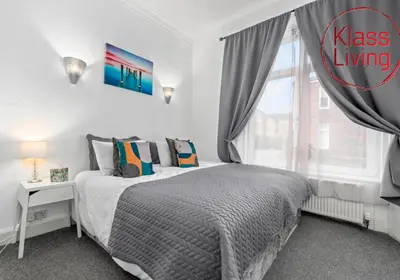 a bedroom with a bed and a window at Elmbank Apartment by Klass Living Bellshill in Bellshill