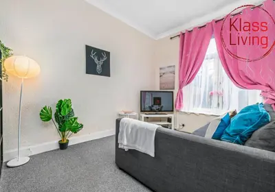 a living room with a couch and a tv at Elmbank Apartment by Klass Living Bellshill in Bellshill